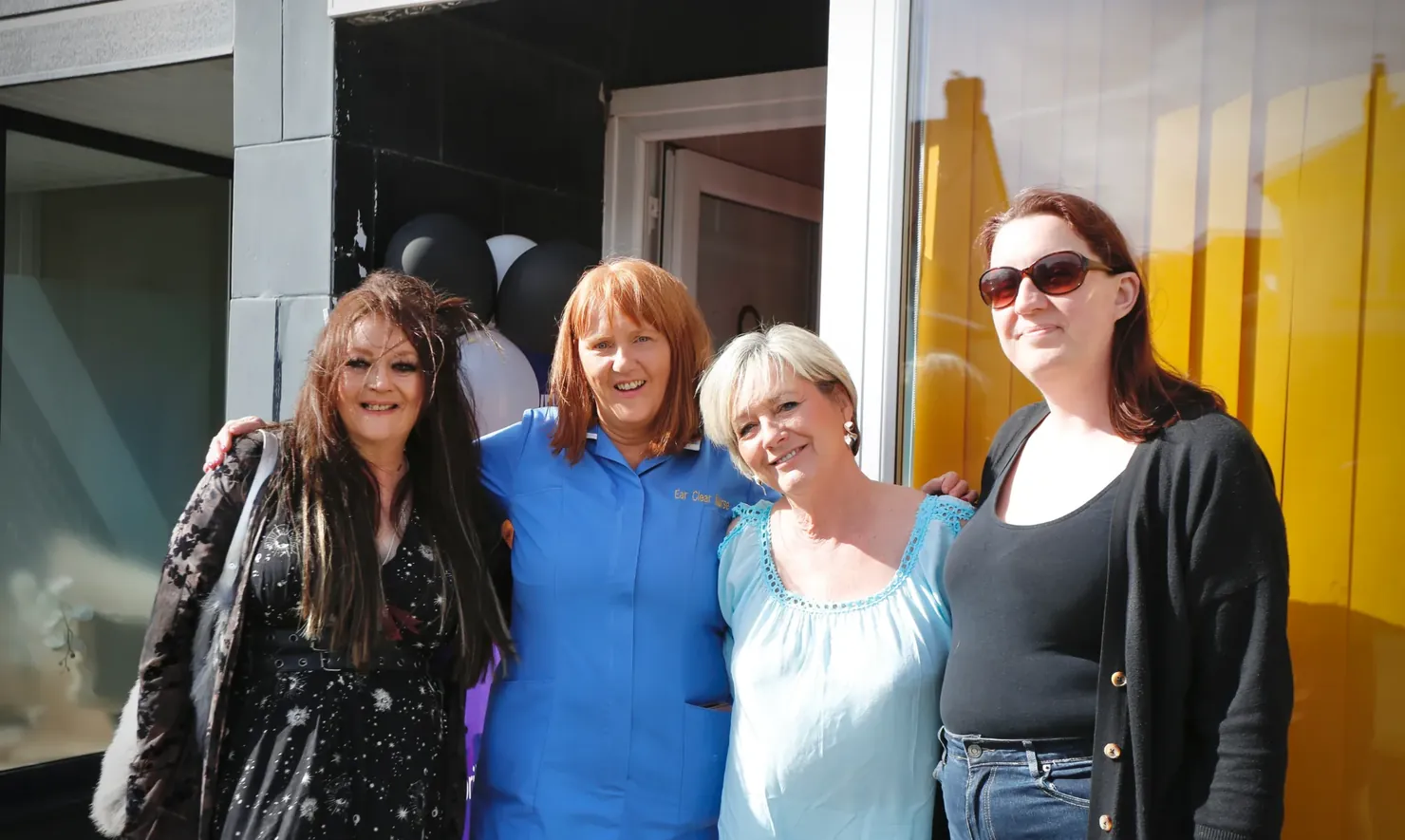 The Ear Clear Nurses team outside the clinic door on opening day